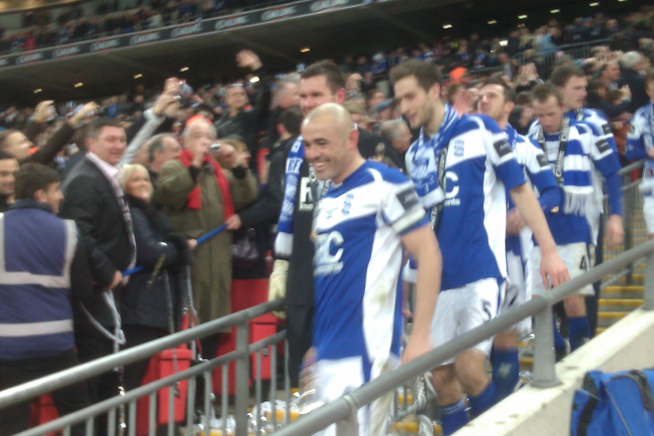 Stephen Carr leads the Blues lads down the steps with the Cup-my grin was wider!